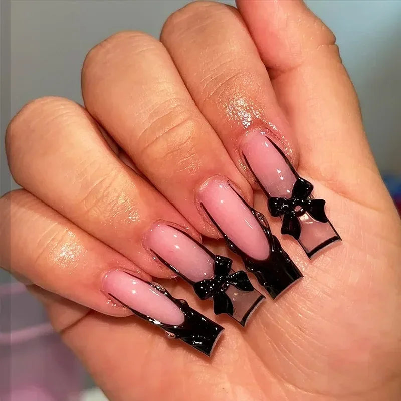 24pcs long coffin French press-on nails in black, featuring elegant bow and diamond details. Chic ballerina-style acrylic nails for a glamorous manicure in minutes.